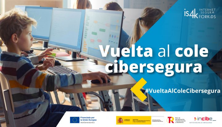 Niños en aula usando computadoras para aprender sobre ciberseguridad.